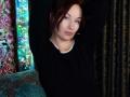 MarleneDavies has pale skin, red hair, and blue eyes, wearing a black shirt with arms raised, looking slightly bored. Her small tits are barely visible.