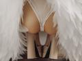 SophieKitty's ass in white panties, framed by white feathers, with her legs in black and white high heels, viewed from behind. Soft, fair skin, slightly bent over.