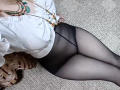 MichaelEuber with black panty-ass, white blouse, and beaded necklace, lying on carpet, wearing sheer black pantyhose, showing a bit of her tits under the blouse.