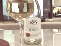 A glass of white wine with a bottle of KWV Moscato Classic standing next to it. KatyBomb's drink.